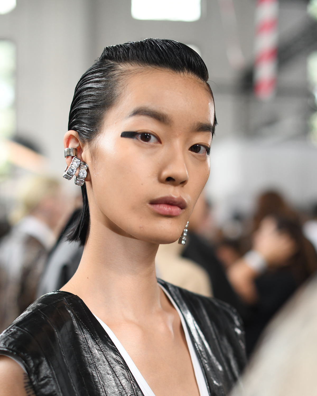 Model backstage wearing black eyeliner