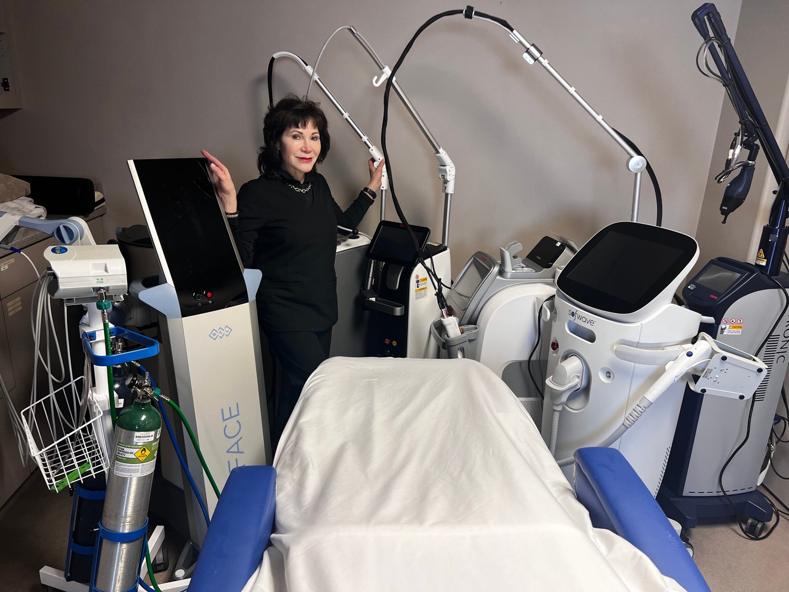 A photo of a woman standing next to equipment at Aesthetic Skin & Laser Center, a med spa in Pittsburgh.
