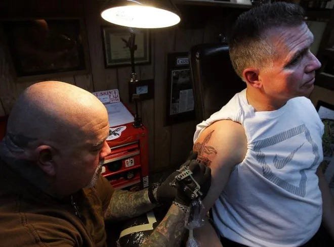 Celebrated tattoo artist dies in crash with cop
