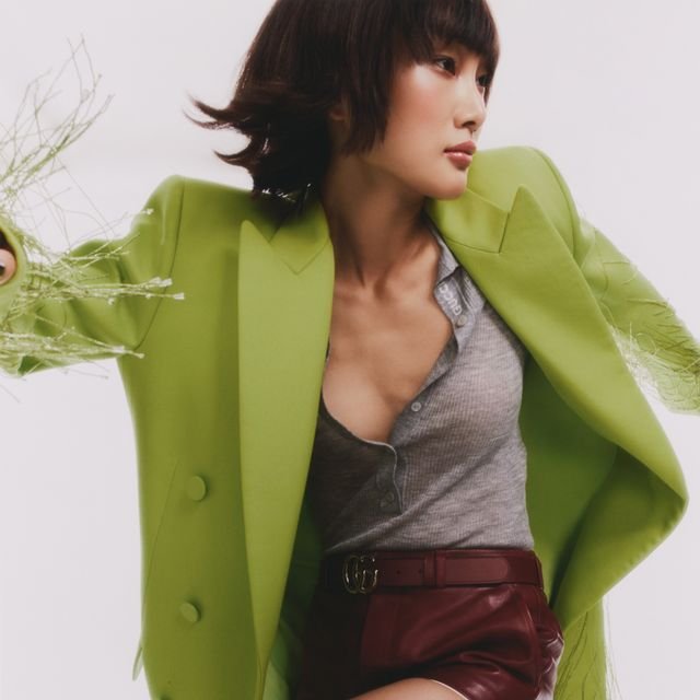 a woman in a green jacket
