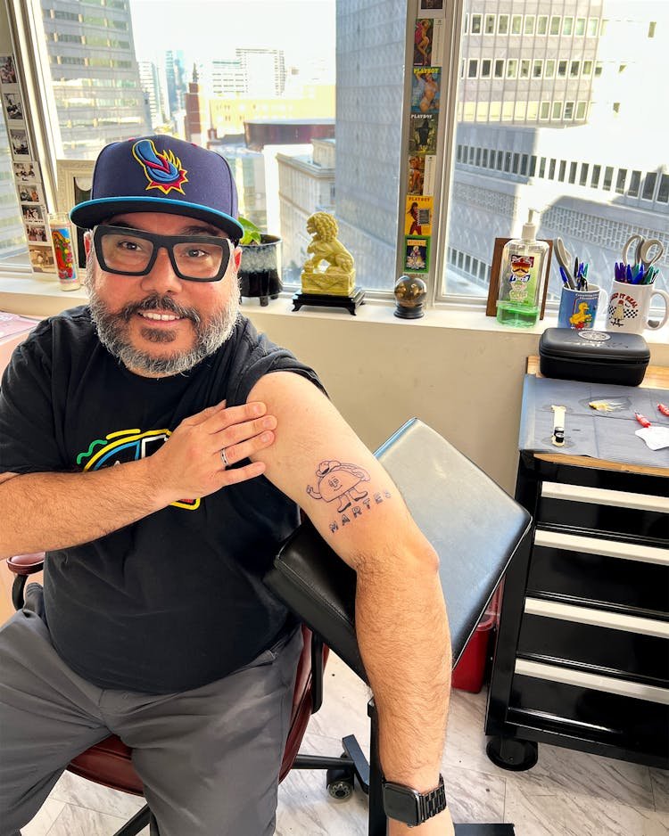 Taco editor José R. Ralat showing off his Martes tattoo at Bat & Cave.