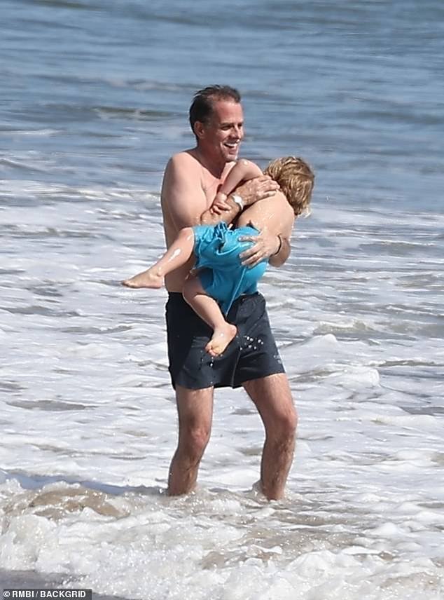 Hunter Biden reveals new back tattoo during beach day with son.