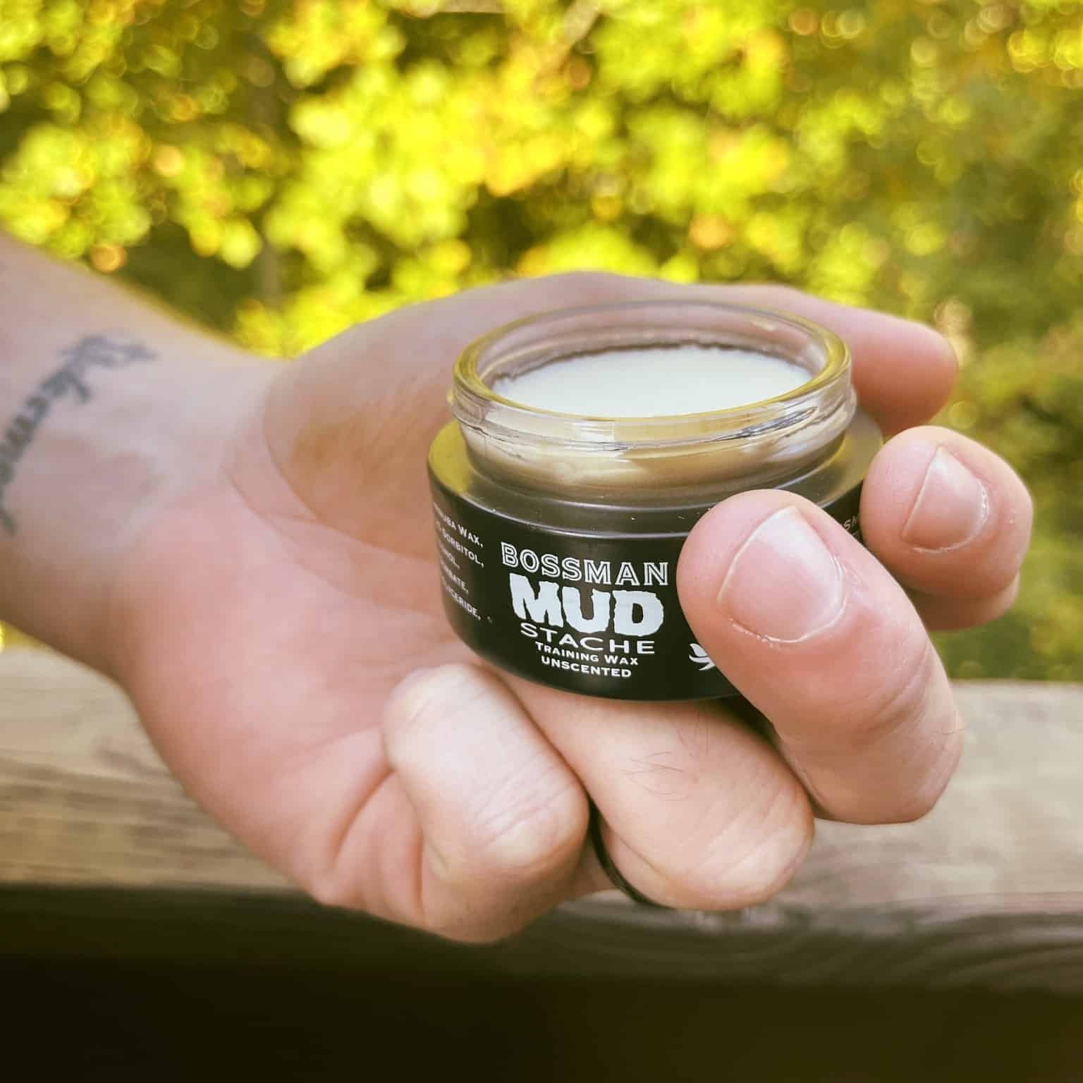 holding the mud stache training wax by bossman