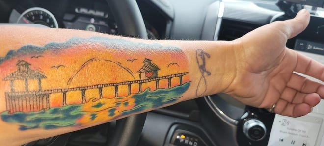 Woman gets stunning sunset tattoo of Fort Myers Beach pier